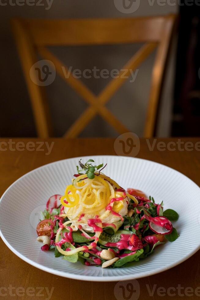 Vegetable salad with radish, arugula and pine nuts photo