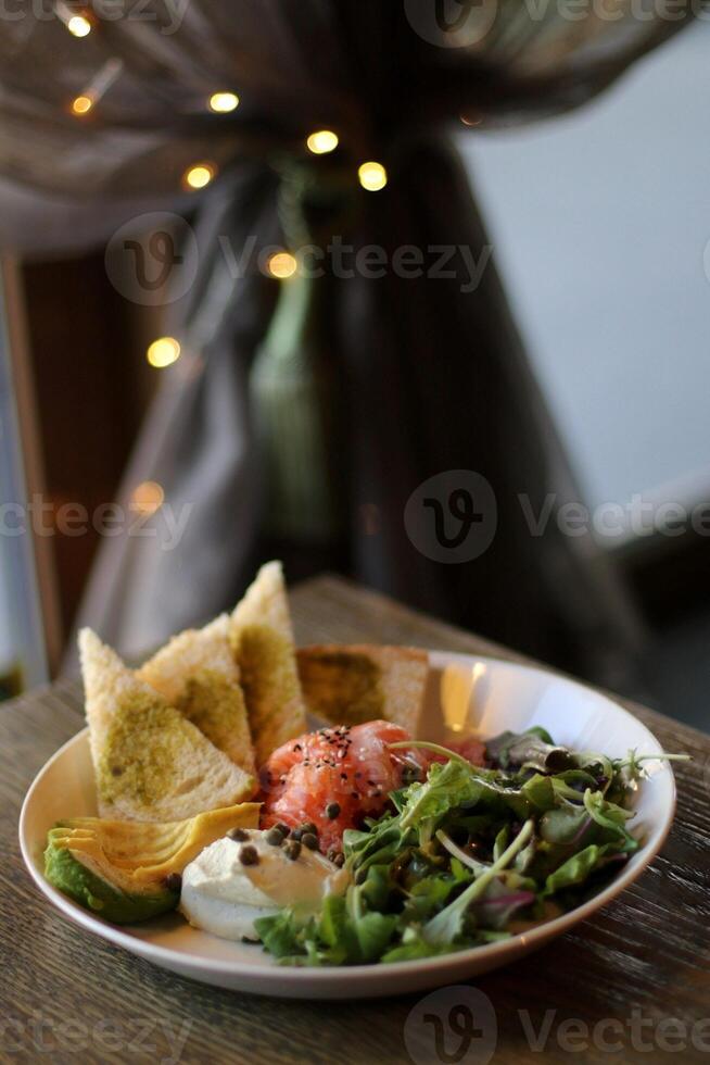 Salmon salad with feta cheese, arugula and bread photo