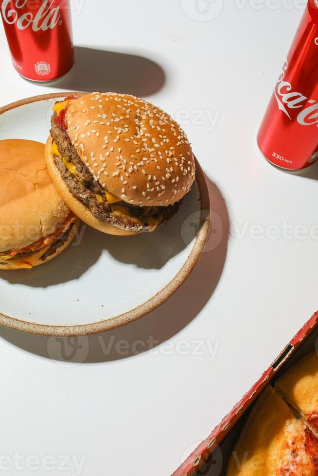Close up of Coca-Cola and hamburger on white background. photo