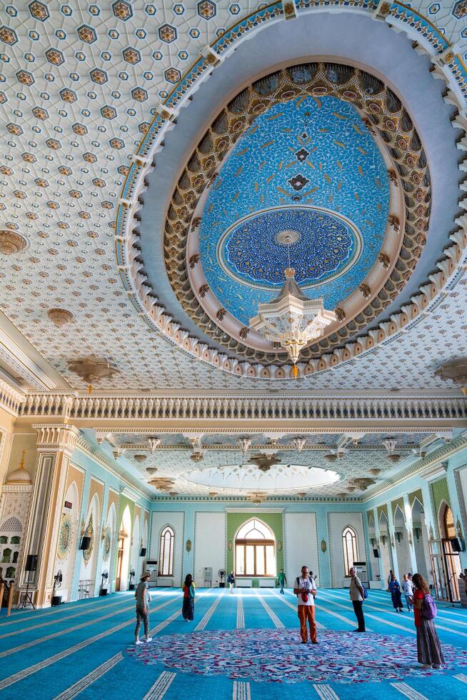 Tashkent, Uzbekistan-august 11, 2023-people visit the Khazrati Imam Mosque in the Hazrati Imam complex during a sunny day. photo