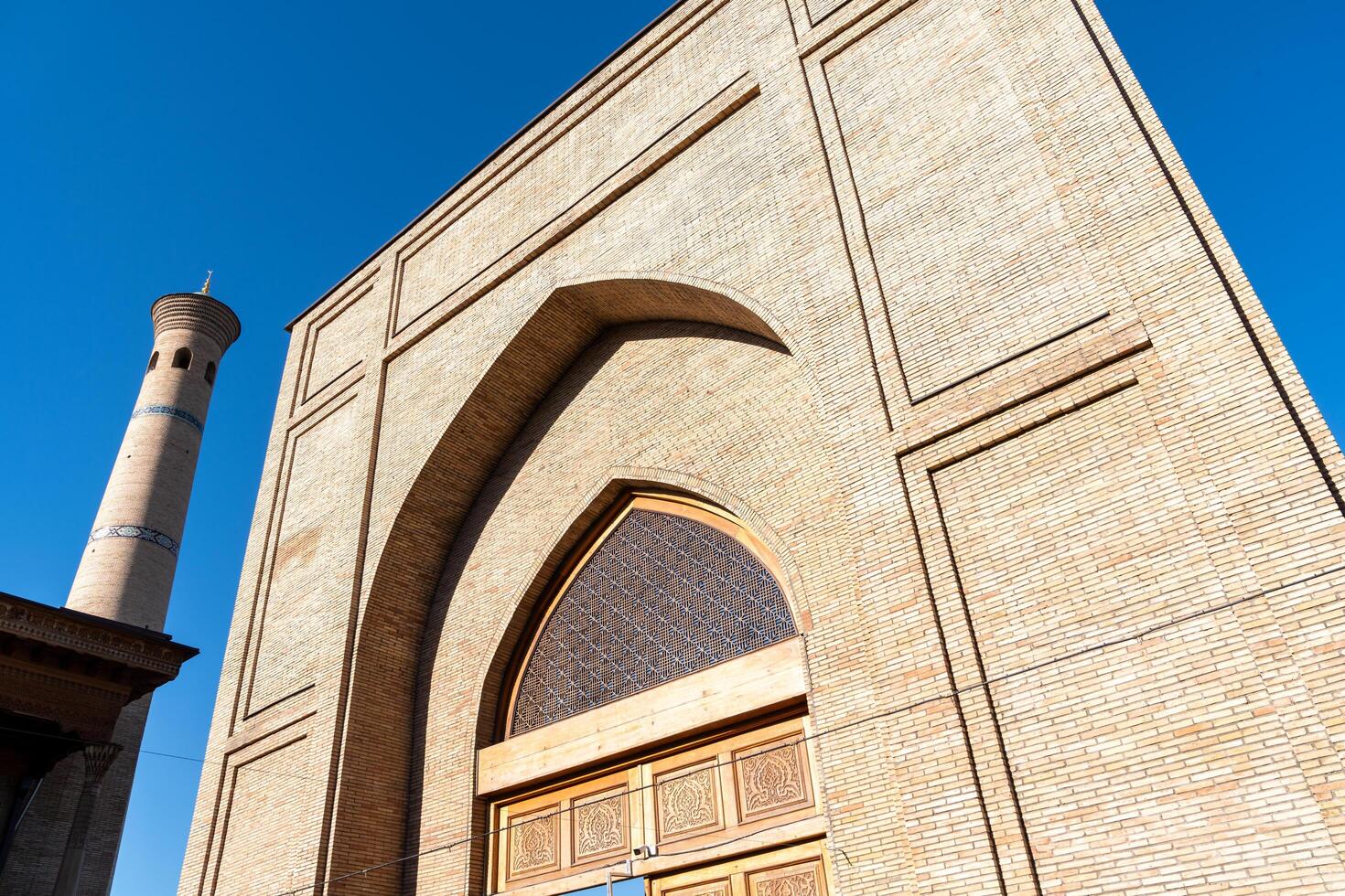 Tashkent, Uzbekistan-august 11, 2023-view of the entrance of the Tillya Sheikh Mosque  during a sunny day.The complex is a square that includes a set of religious buildings in Tashkent photo
