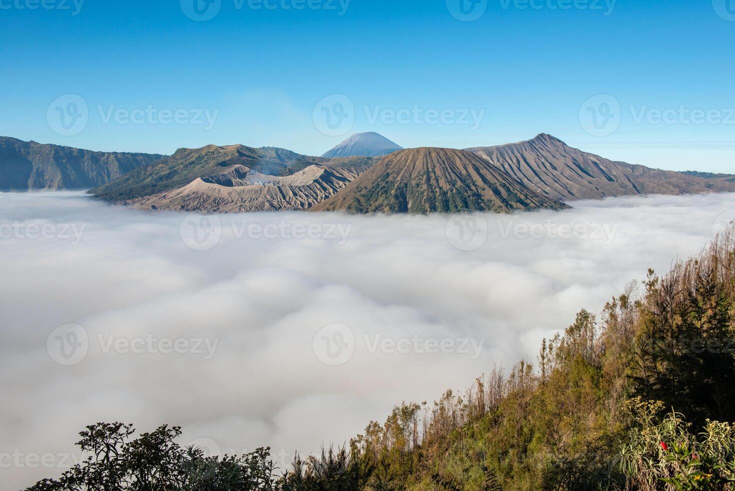 Beautiful landscape of the volcano complex in Bromo Tengger Semeru National Park with sea of fog in the morning. Bromo is one of the most tourist attraction spot in East Java, Indonesia. photo