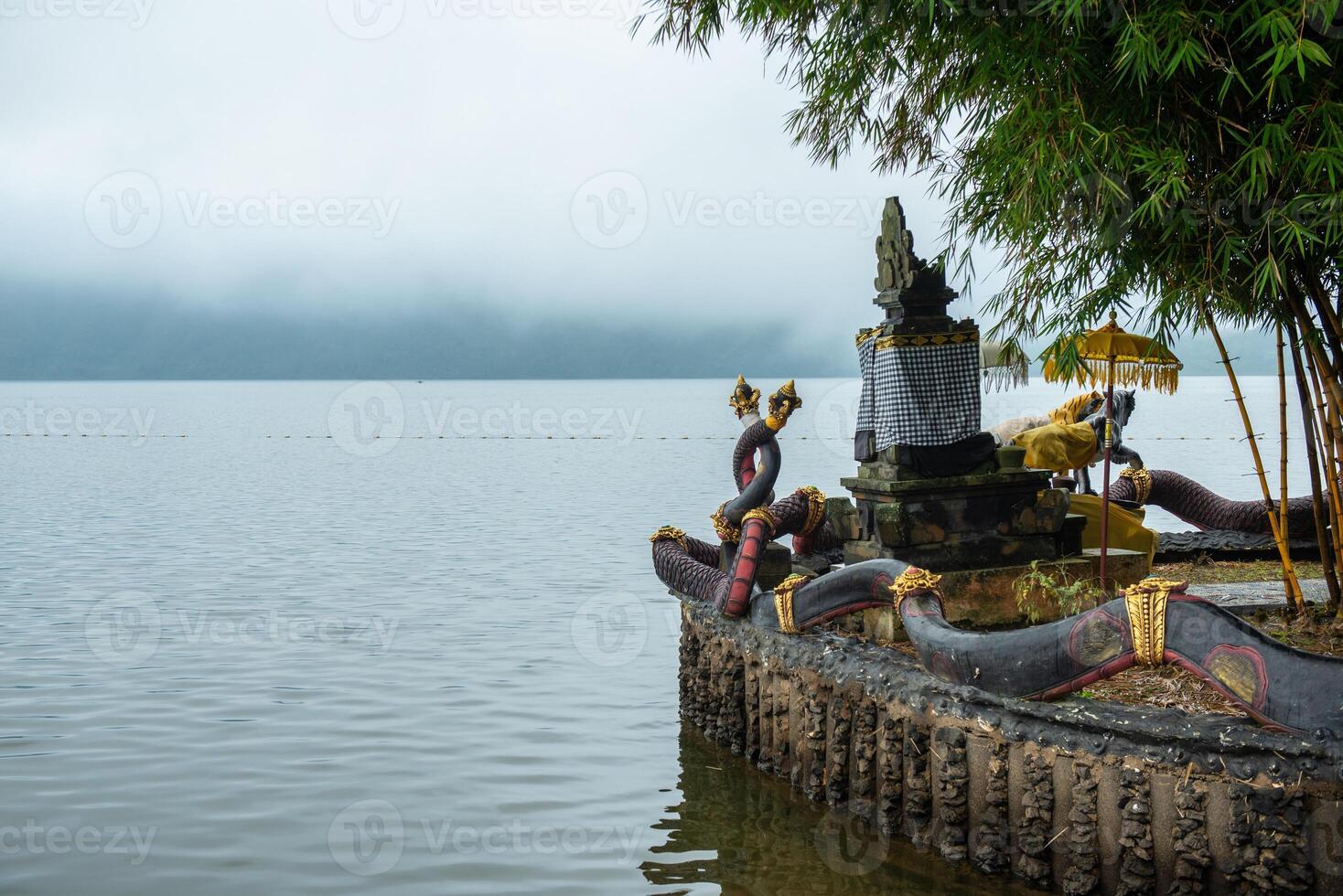 Spiritual shrine in Pura Ulan Danu Bratan temple at the shore of lake Bratan the second largest lake in Bali, Indonesia in the morning. photo