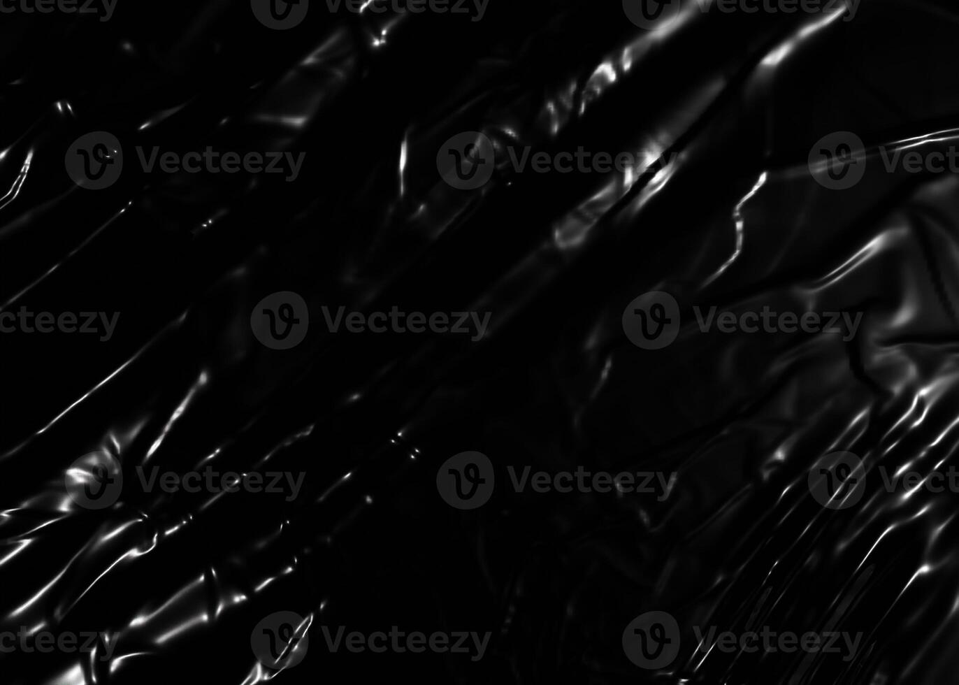 Wrinkled plastic wrap texture on a black background photo