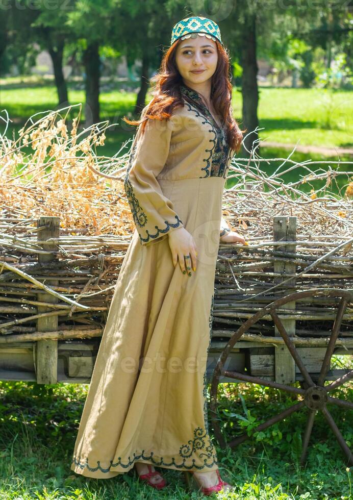 Armenian young woman in traditional clothes in the nature in summer photo