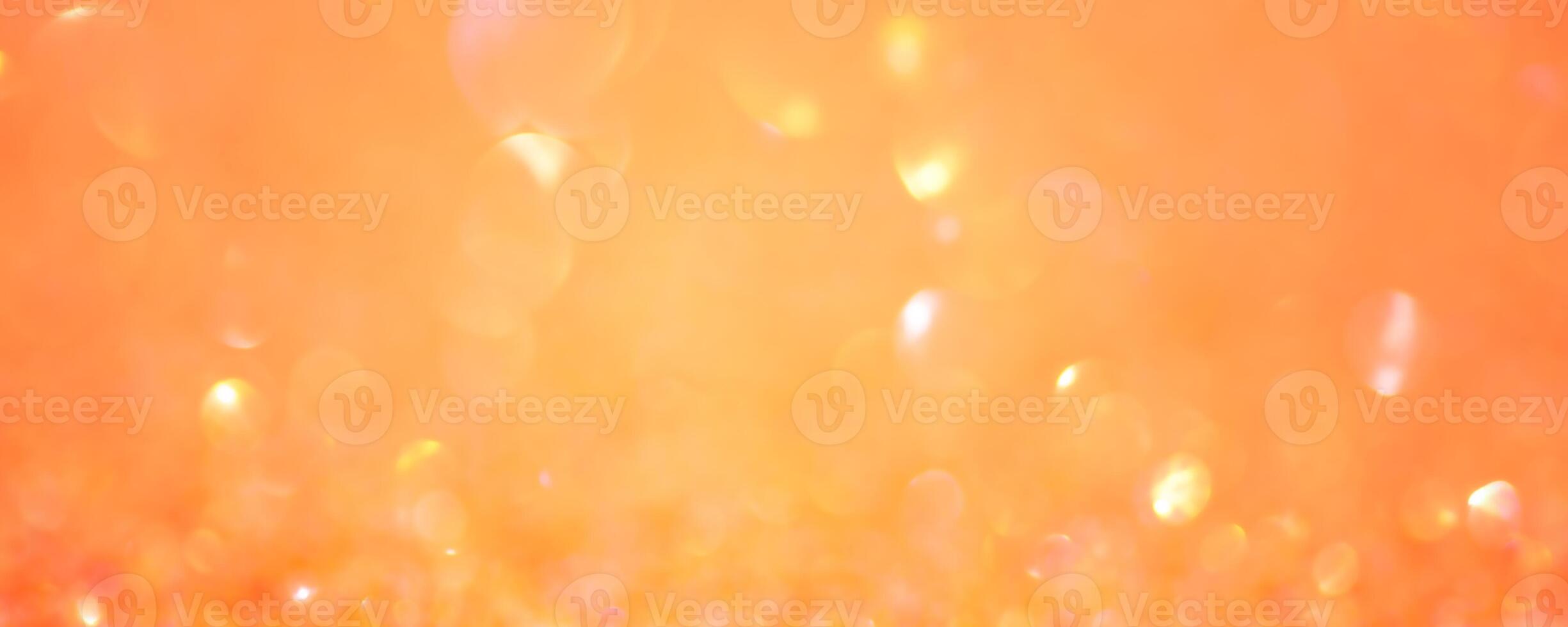 Sparkles defocus light. Orange background and yellow defocus. Background banner size. photo