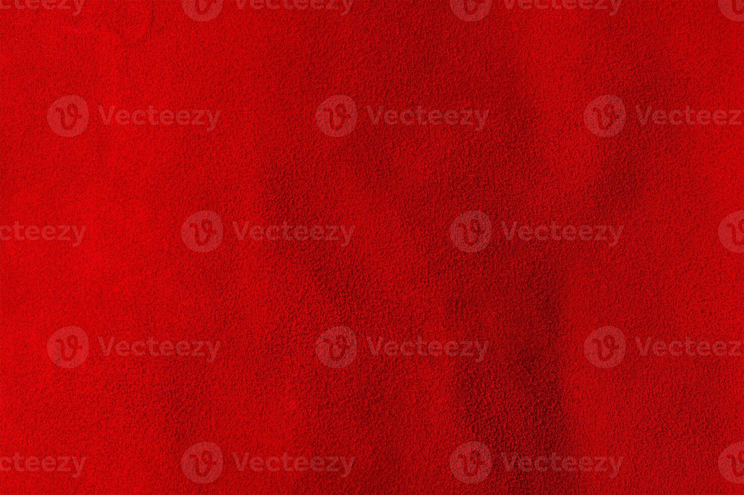 Red background from a natural suede piece of material. Macro photo of red velvet texture.