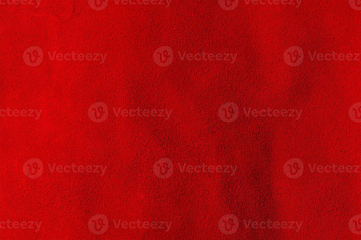 Red background from a natural suede piece of material. Macro photo of red velvet texture.