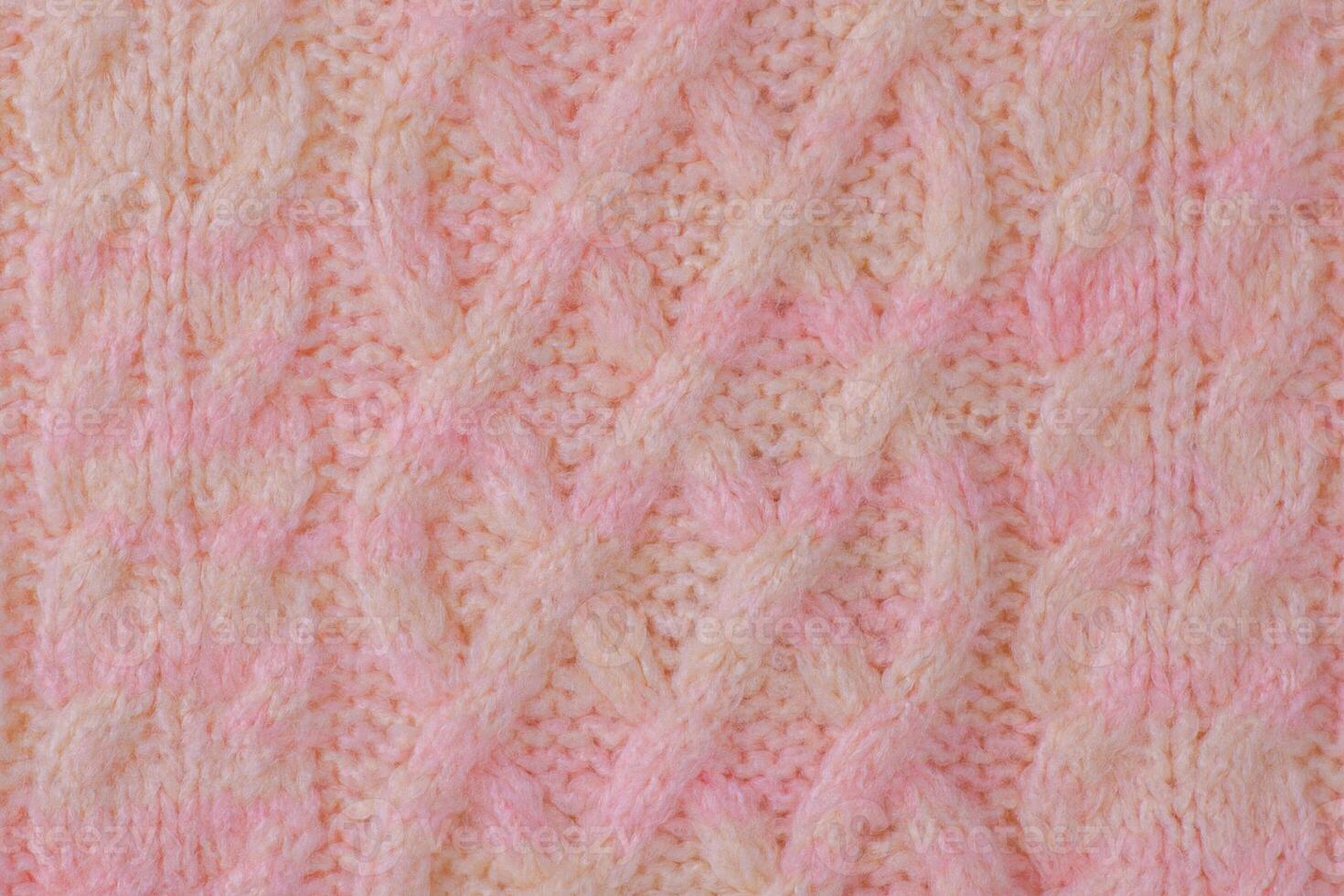 Pink and beige detail of a knitted item. Terry knitted texture as a macro photo background.
