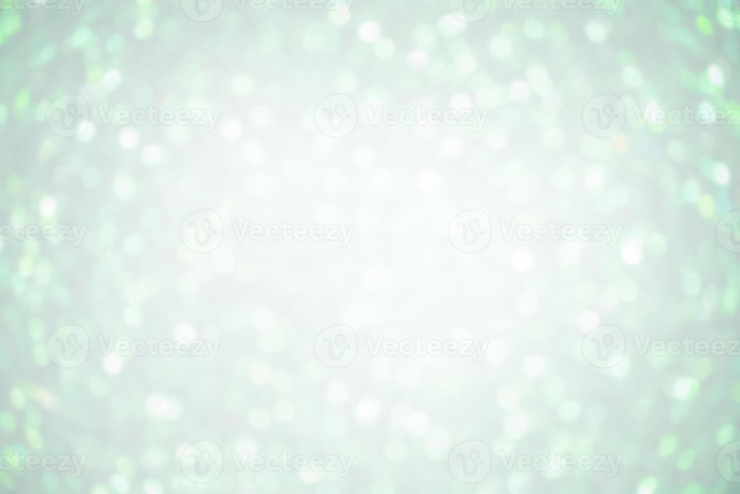 Defocus lights white on light green color. Abstract background with blurred sparkles. photo