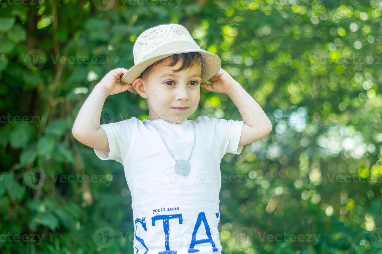 pretty boy in a hat, boy in the park photo