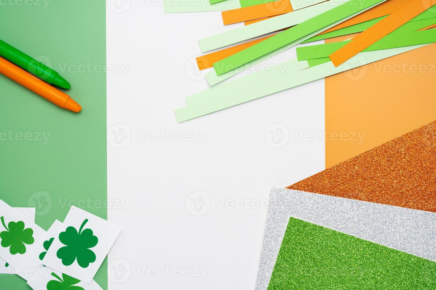Irish flag made from color paper with cut out shamrock clover crayons and glitter paper photo