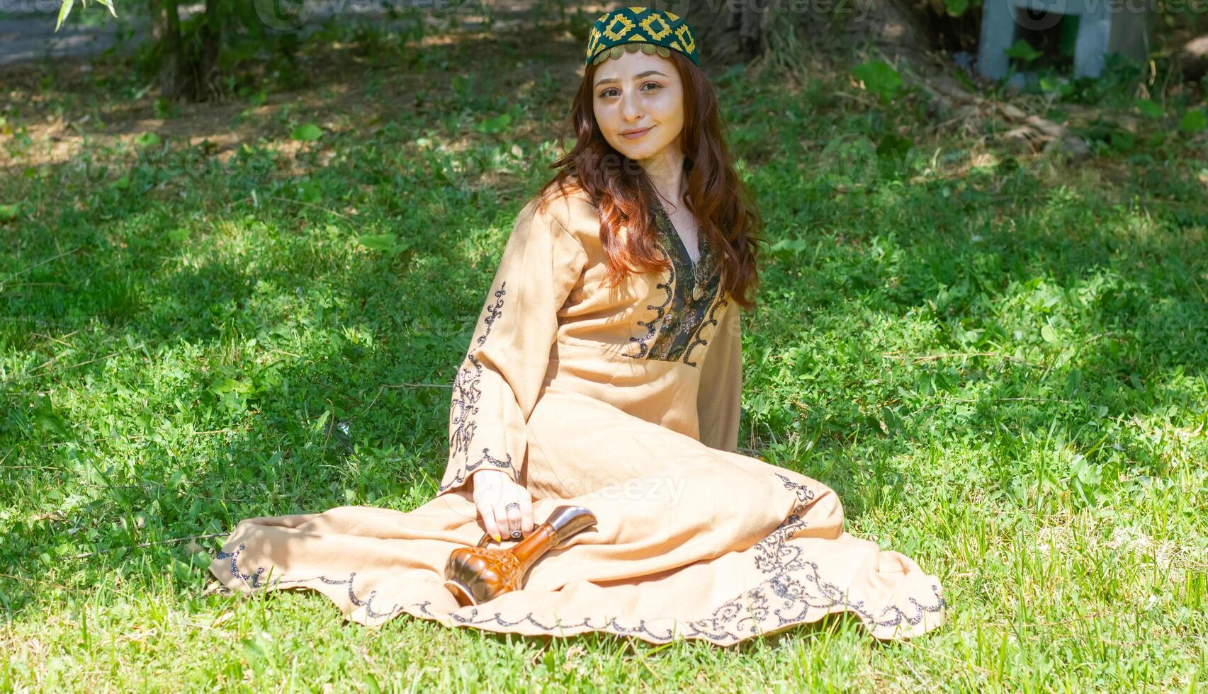 Armenian young woman in traditional clothes in the nature in summer photo