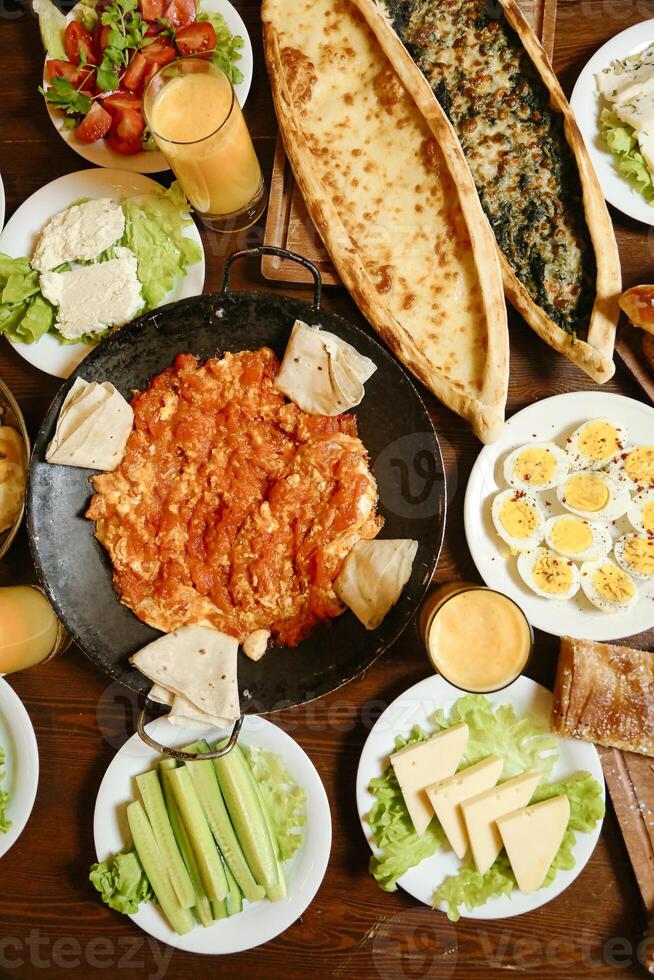 Wooden Dining Table Displaying Plates of Food photo