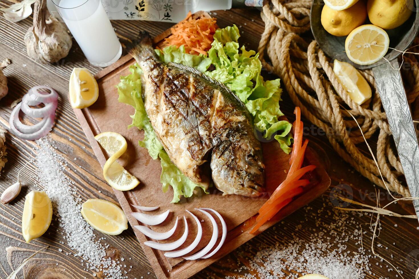 Wooden Cutting Board With Fresh Fish and Vegetables photo