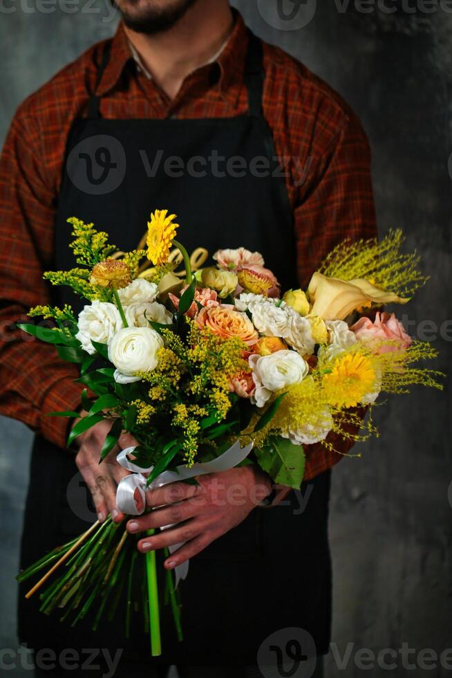 Man in Apron With Flower Bouquet photo