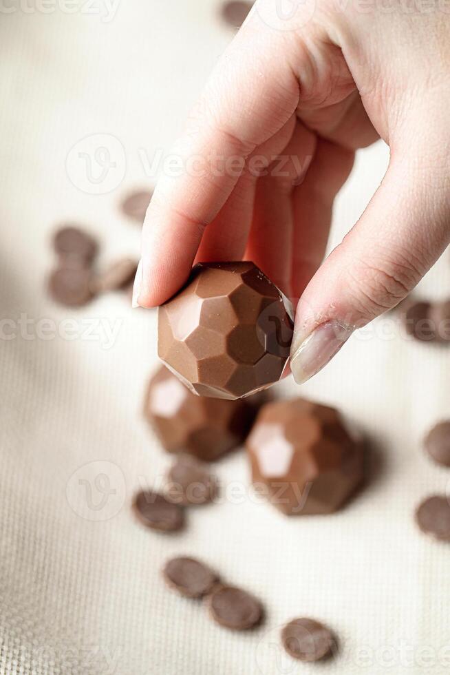 Person Holding a Chocolate Ball in Their Hand photo