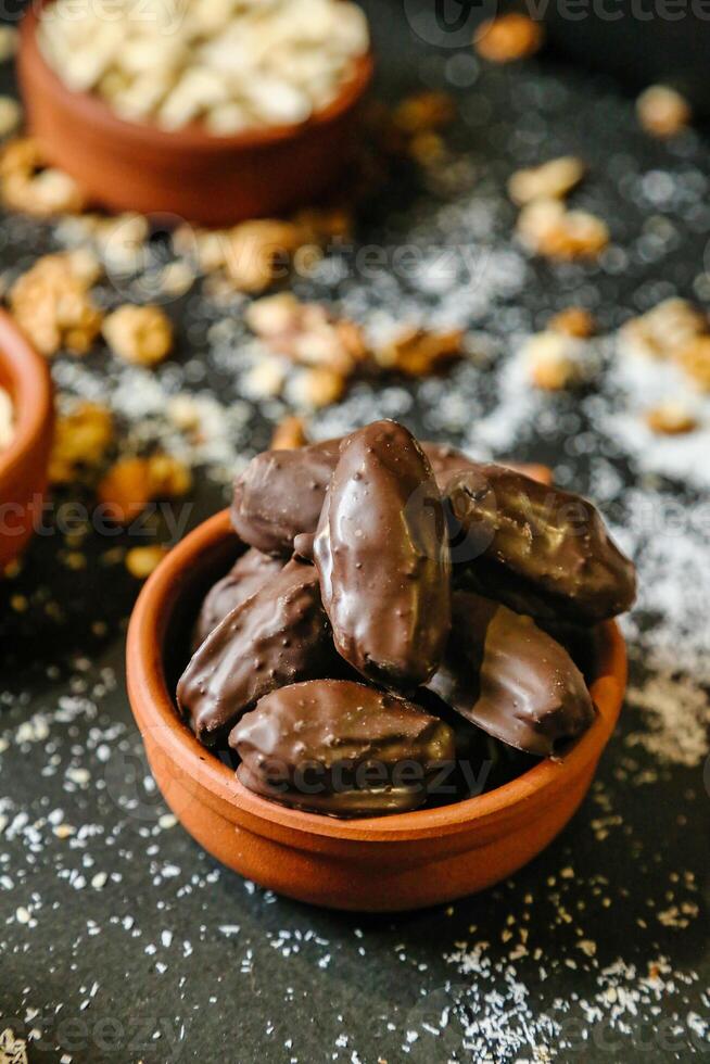 Wooden Bowl Filled With Chocolate Covered Almonds photo