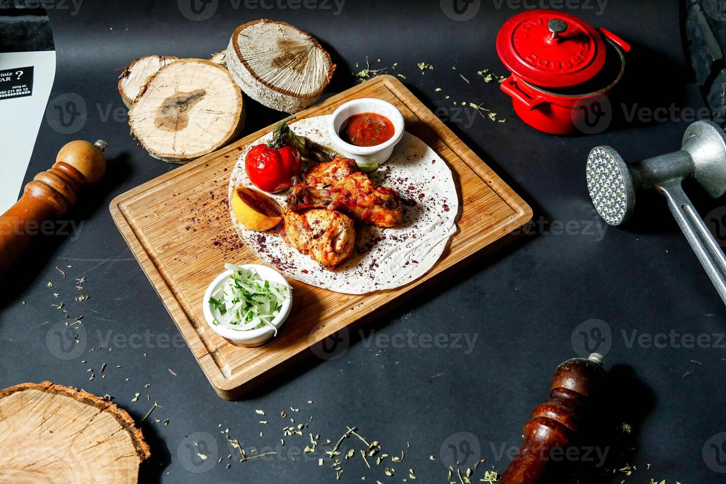 Wooden Cutting Board With Food Next to Laptop photo