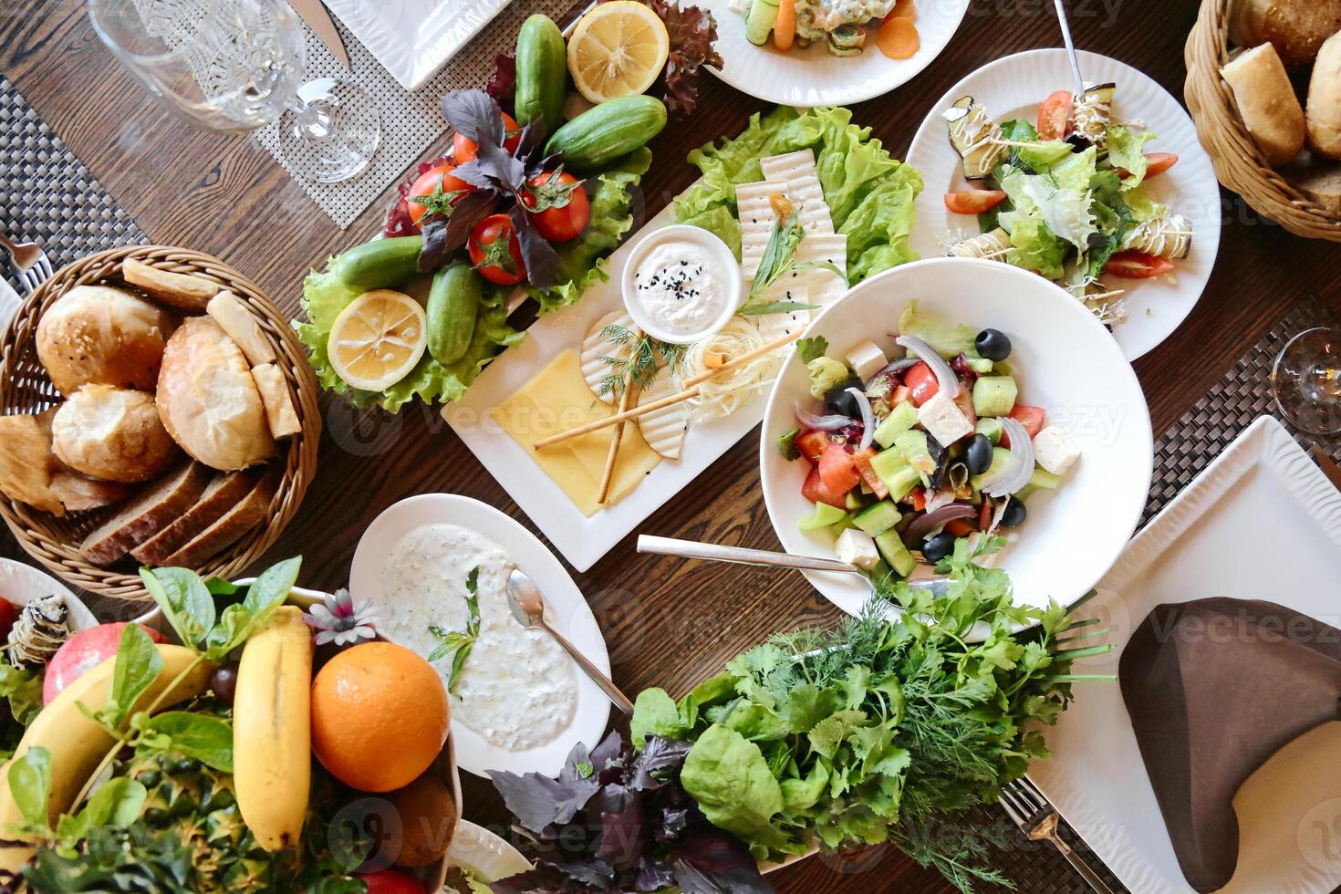 Abundant Feast on a Table With a Variety of Plates Filled With Food. photo