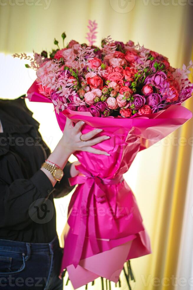 Woman Holding Large Bouquet of Flowers photo