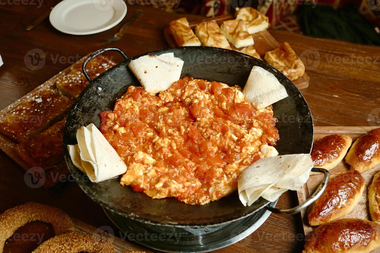 A Pan Filled With Food on a Wooden Table photo