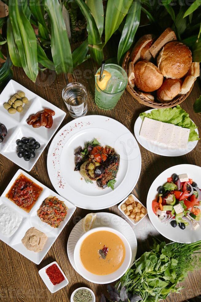 Wooden Table With Delicious Plates of Food photo