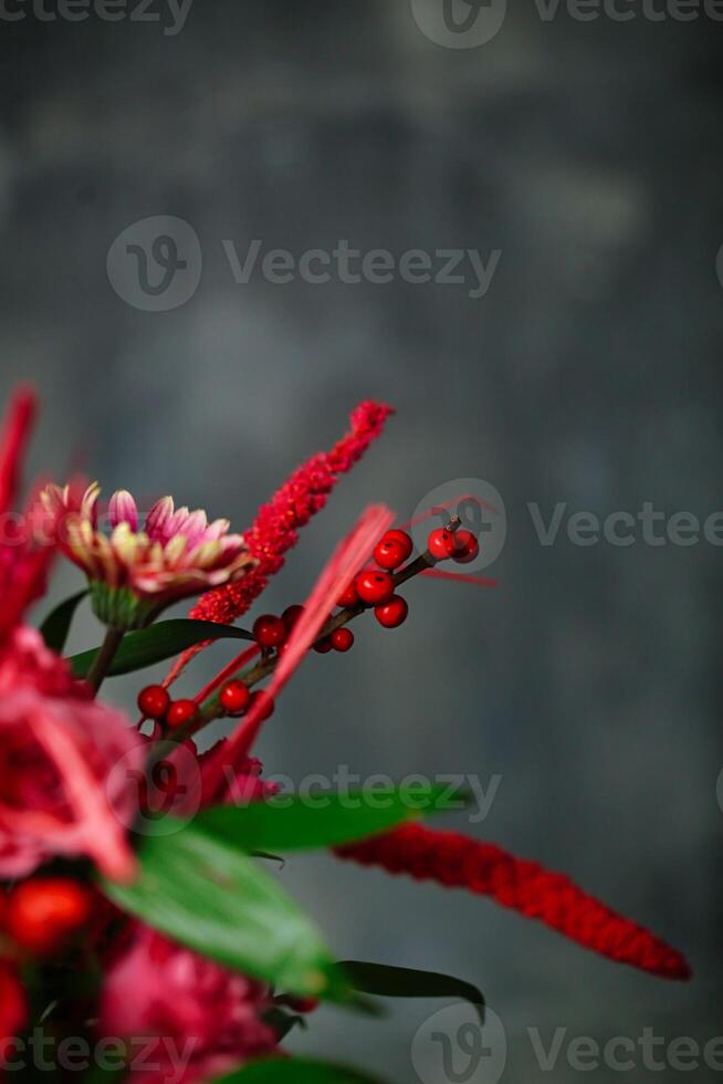 Vase With Red Flowers and Green Leaves photo