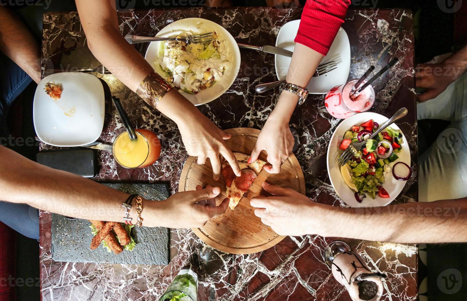 Group of People Standing Around a Table With Plates of Food photo