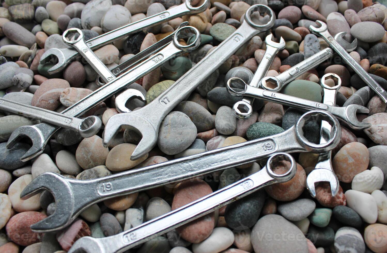 Ring End And Open End Wrenches On A Pebbles Angle View photo