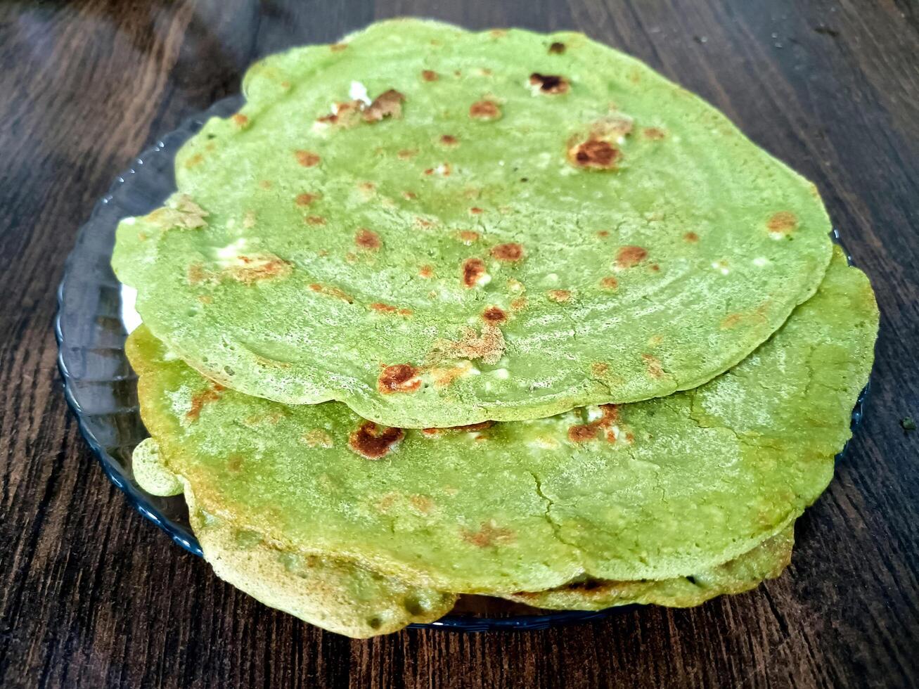 Palak paratha or Indian flat breads made from spinach and served with mango pickle and mint dip, Indian breakfast photo