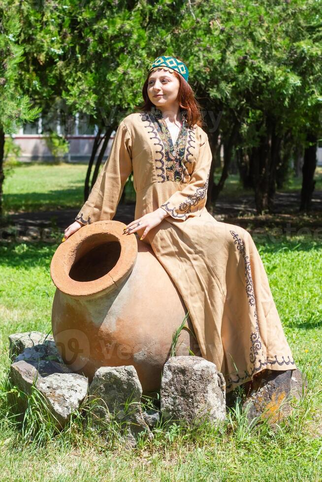 Armenian young woman in traditional clothes in the nature in summer photo