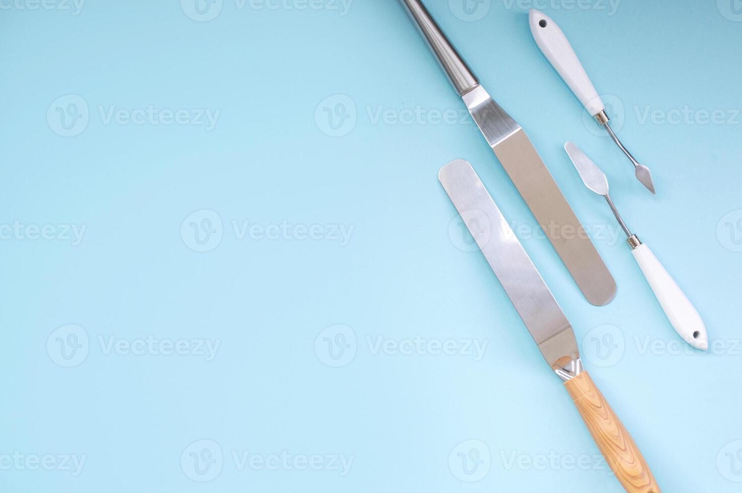 A set of tools for a confectioner, a spatula for decorating a cake with cream, a place for text photo