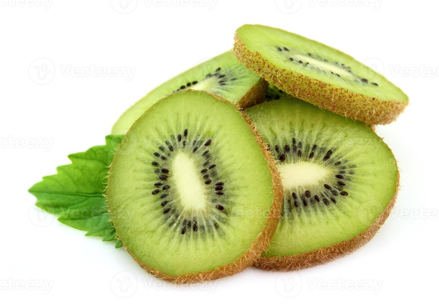 Segments of a kiwi with leaves photo