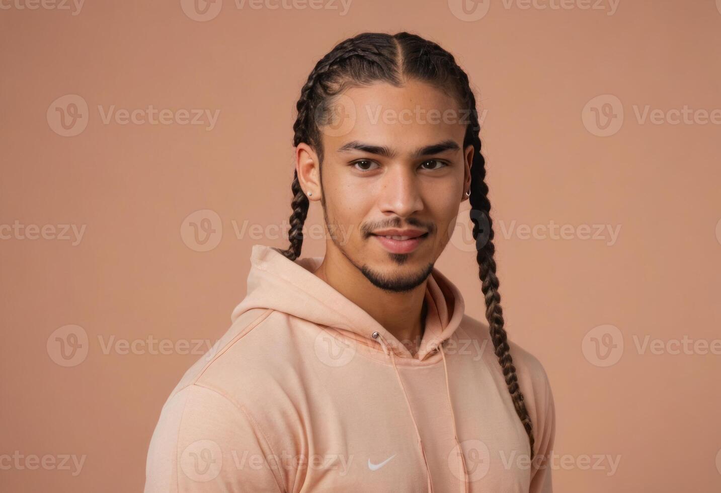 AI Generated A stylish man with long braided hair, wearing a soft pink hoodie, and looking away thoughtfully. photo