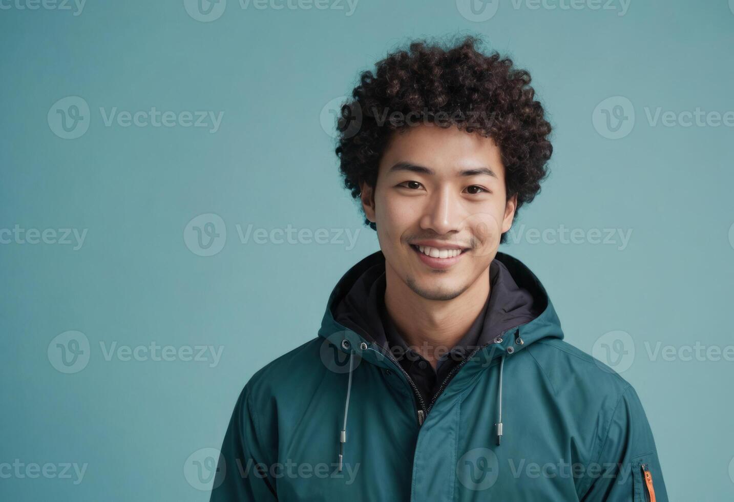 AI Generated A man with curly hair smiles in a casual outdoor jacket, appearing comfortable and trendy against the teal background. photo