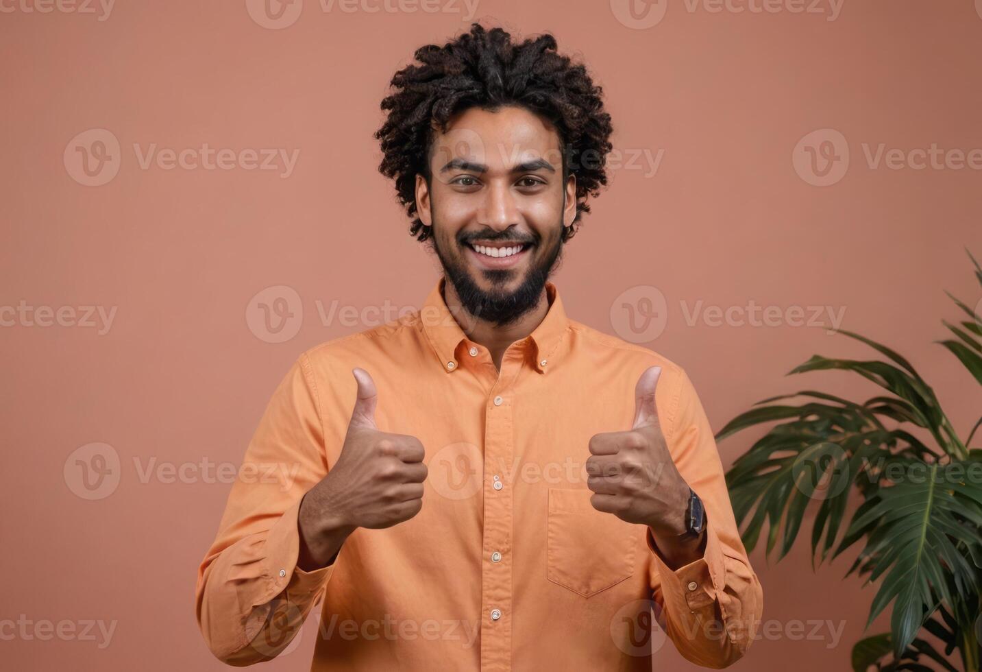 AI Generated A joyful man with curly hair giving double thumbs up, peach background with plant. He radiates happiness and assurance. photo
