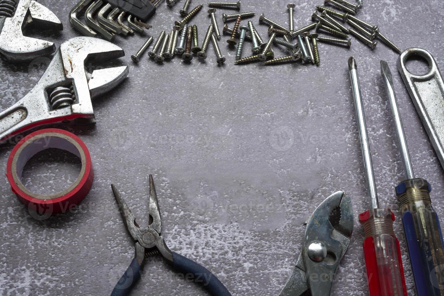 Old tools on concrete floor. Renovation, maintenance and repairing concept. photo