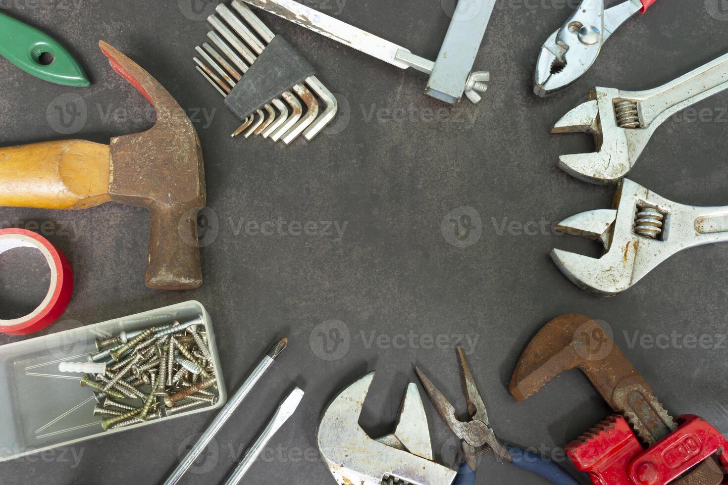 Old tools on concrete floor. Renovation, maintenance and repairing concept. photo