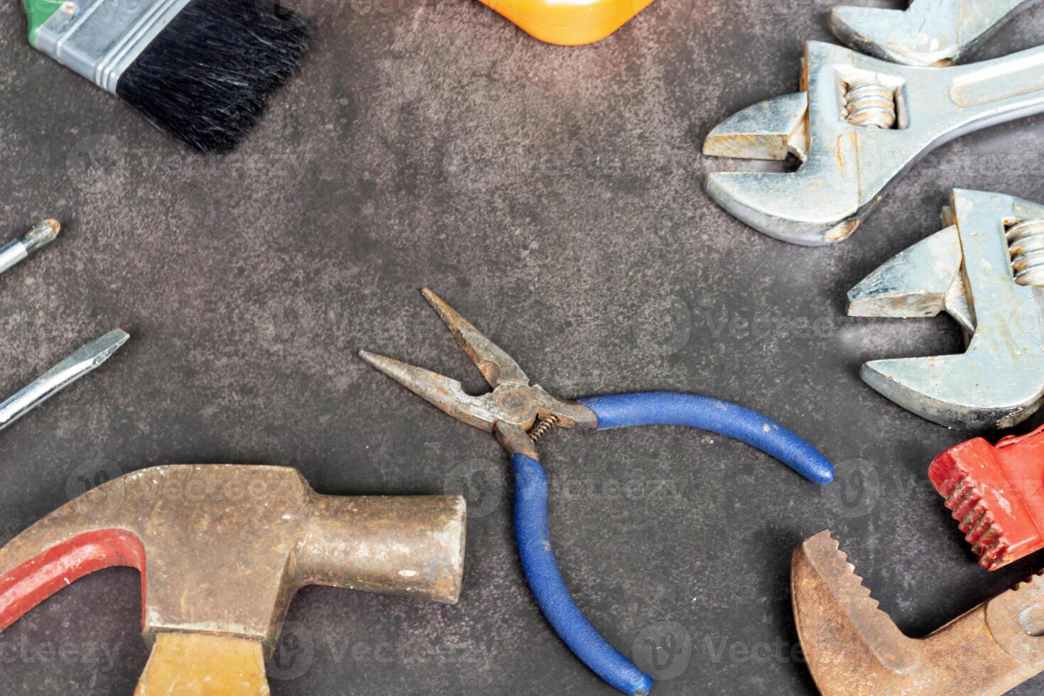 Old tools on concrete floor. Renovation, maintenance and repairing concept. photo