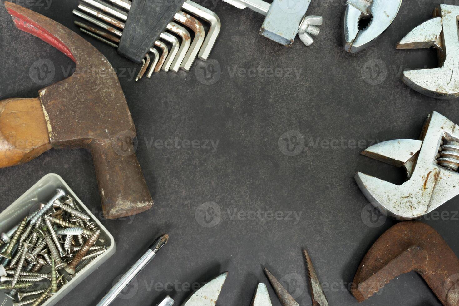 Old tools on concrete floor. Renovation, maintenance and repairing concept. photo