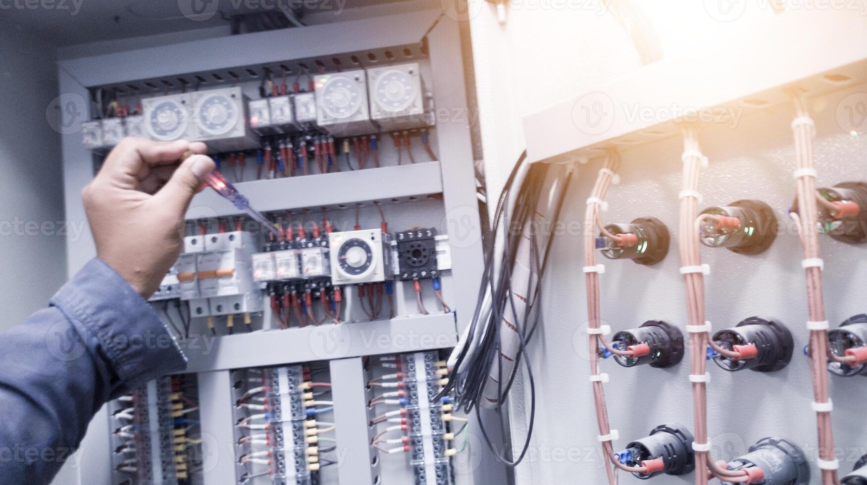 Checking the electrical power on the control panel using a test pen. photo