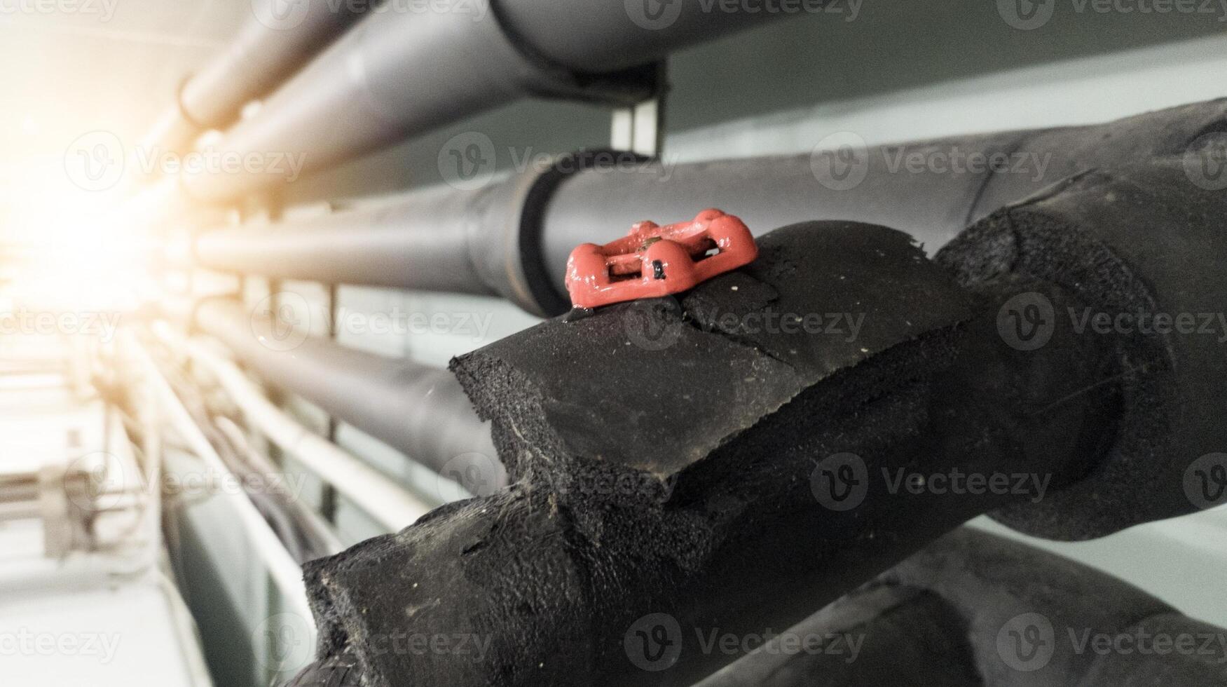 Installation of water chiller pipes with insulation and supply water on the stop gate valve. photo