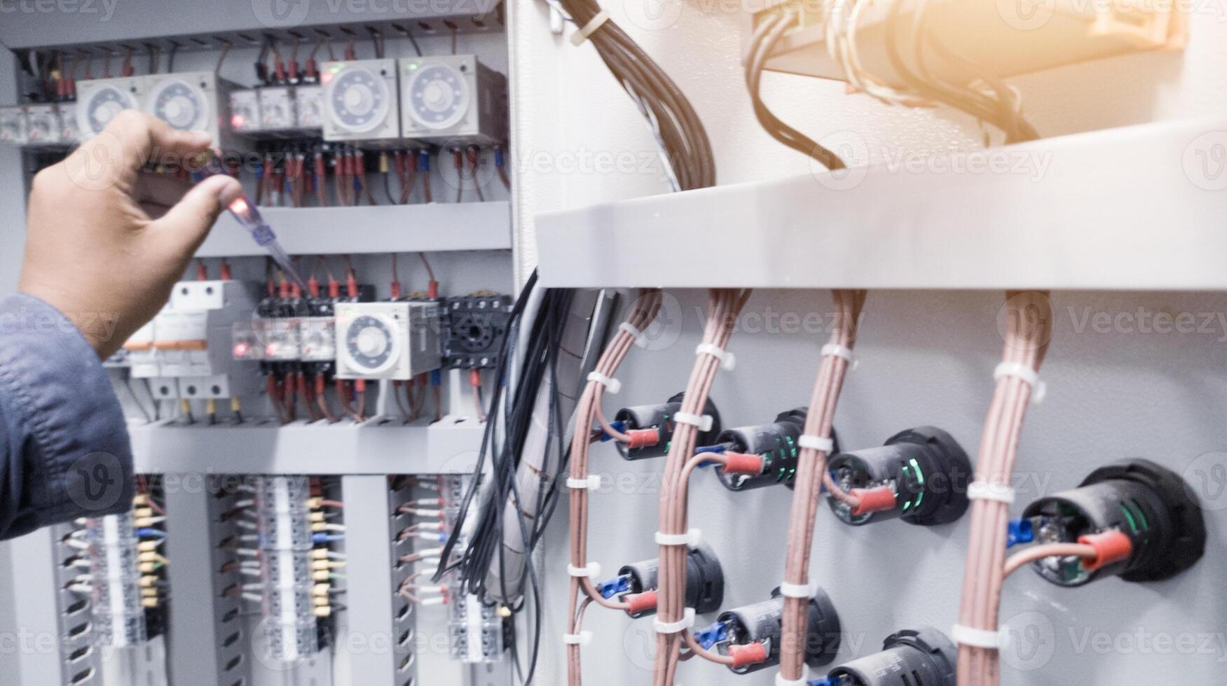 Checking the electrical power on the control panel using a test pen. photo