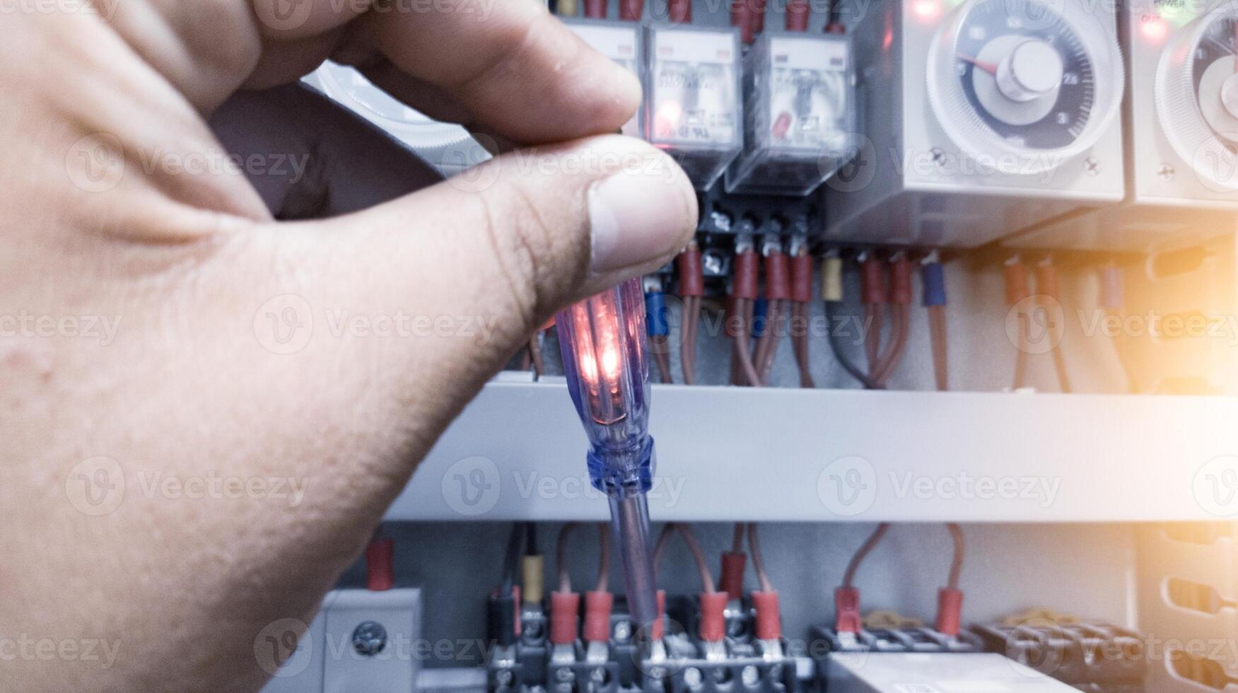 Checking the electrical power on the control panel using a test pen. photo