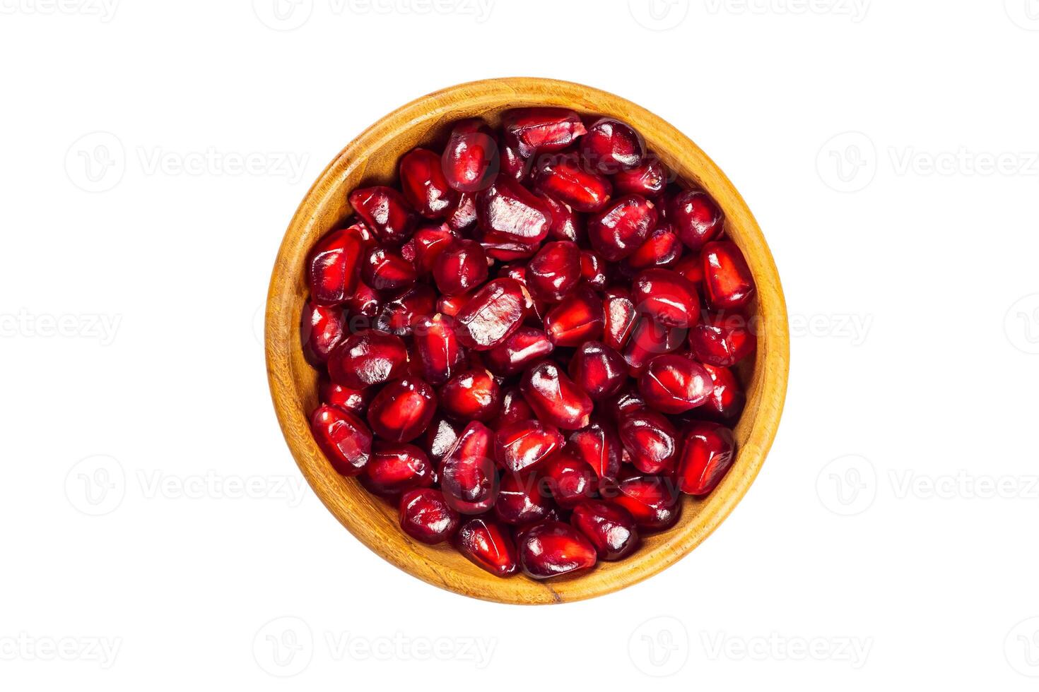 Top view of fresh ripe pomegranate seeds in wooden bowl isolated on white background with clipping path. photo