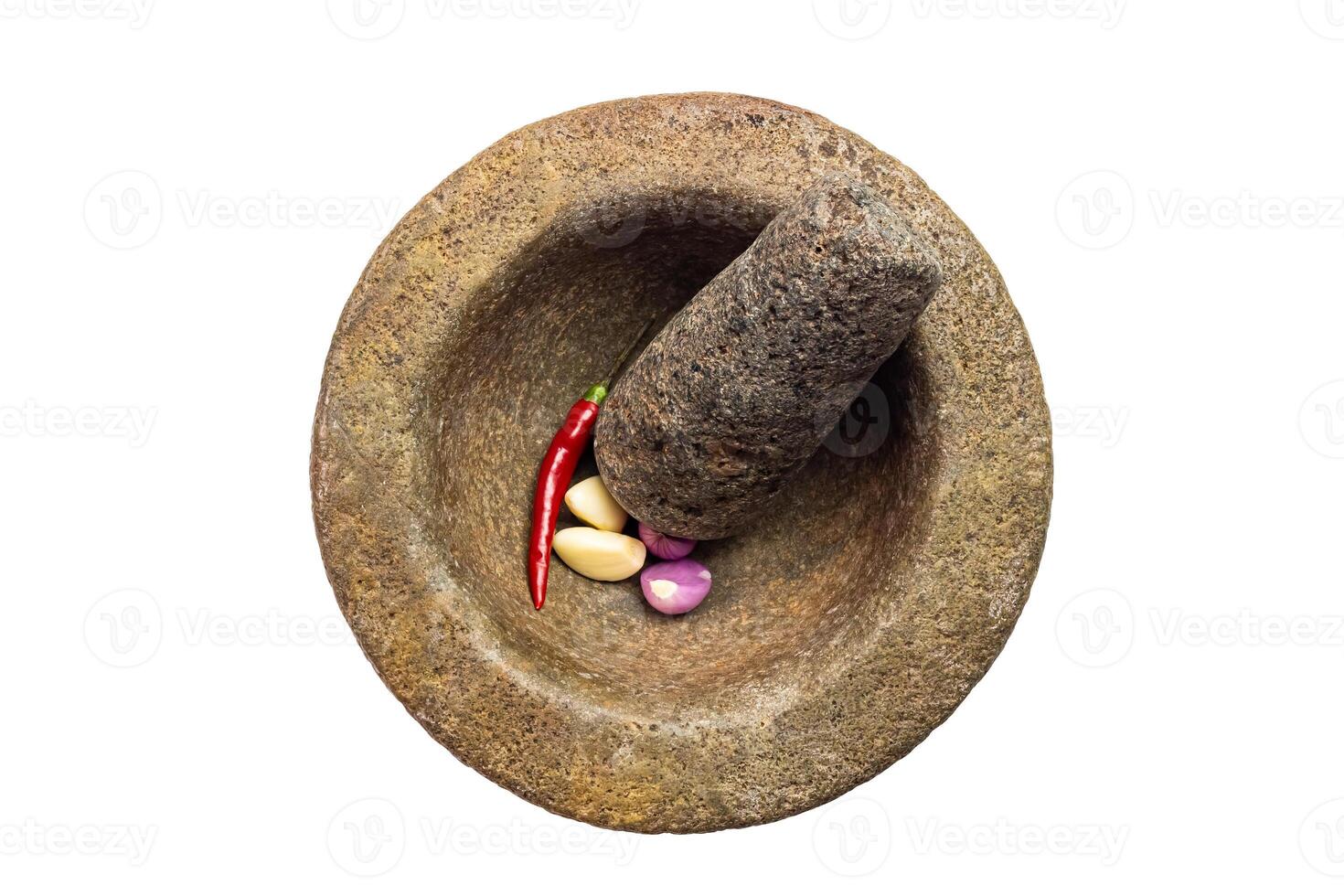 Top view of old used rock mortar with pestle and red chili, onion and garlic isolated on white background with clipping path. photo