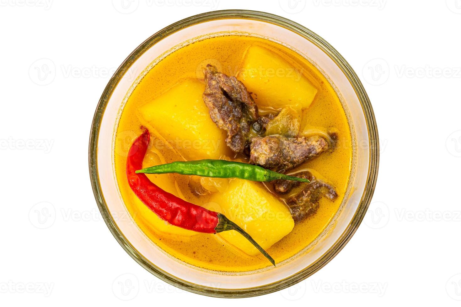Top view of delicious homemade yellow curry with pieces of potato, beef, onion and coconut milk in white ceramic bowl isolated on white background with clipping path. photo