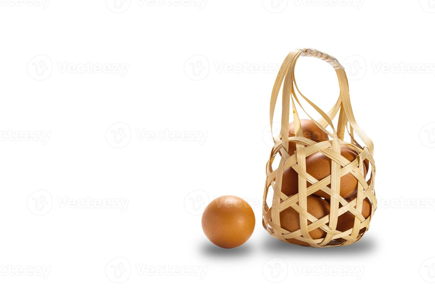 Group of fresh chicken eggs in bamboo basket isolated on white background with clipping path. photo