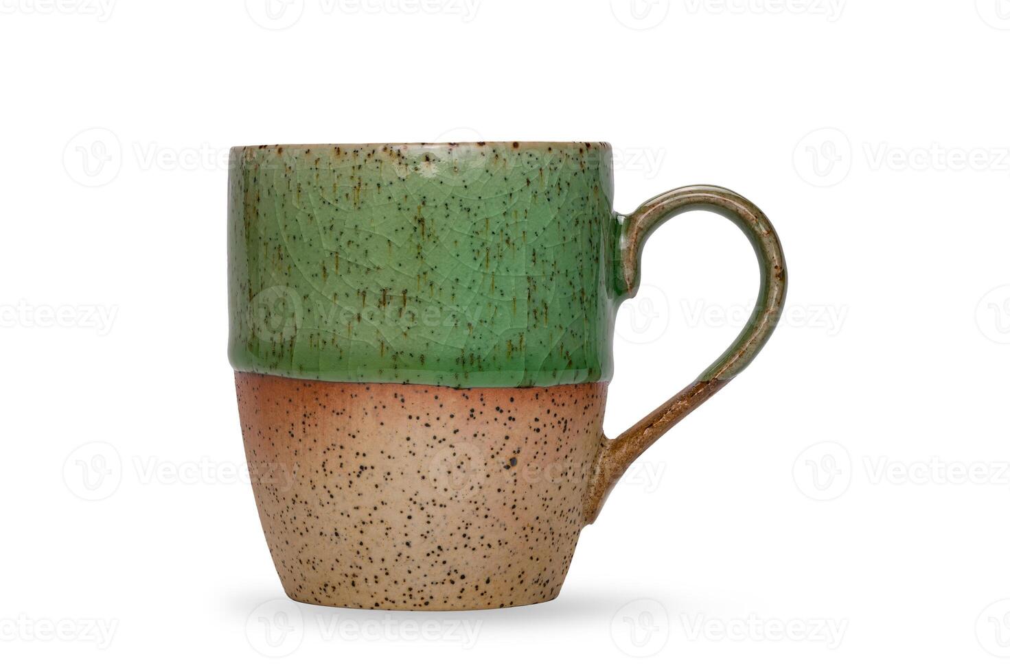 Empty beautiful bicolored green and brown glazed ceramic coffee mug or tea mug isolated on white background with clipping path. photo